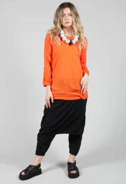 Round Neck Long Sleeved T Shirt with Bell Sleeves in Orange